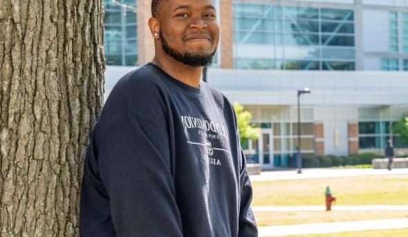 Headshot of Craig Rollins standing by a tree wearing an ODU sweatshirt